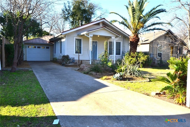 view of front of property with a garage and a front lawn