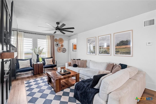 living room featuring dark hardwood / wood-style flooring and ceiling fan