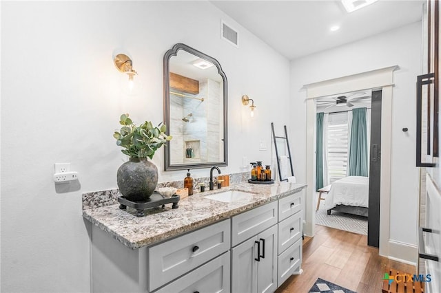 bathroom featuring hardwood / wood-style flooring, ceiling fan, and vanity