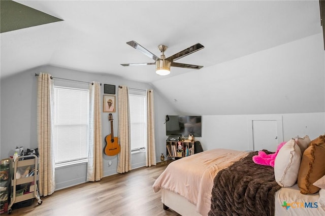 bedroom with hardwood / wood-style flooring, ceiling fan, and lofted ceiling