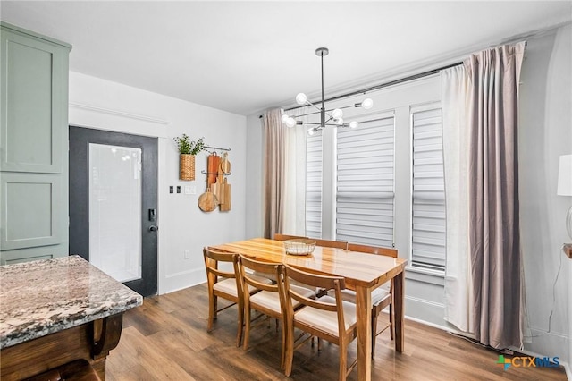 dining area with a chandelier and light wood-type flooring