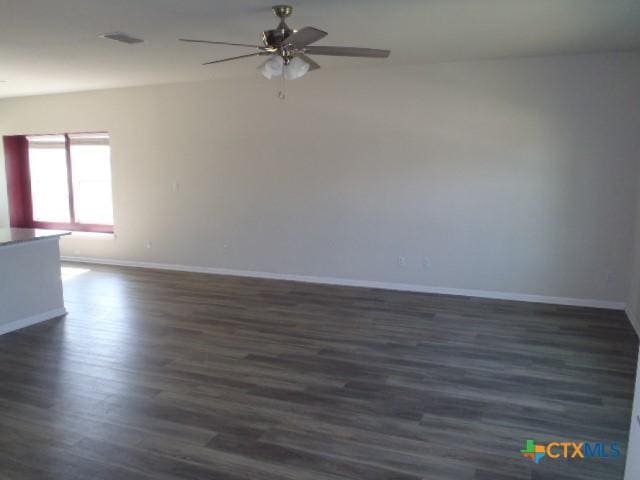 302 Mossycup Dr, San Marcos, TX 78666 - spare room with dark wood-style flooring, baseboards, and a ceiling fan
