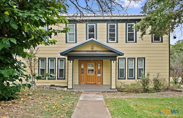 view of front of house featuring a front lawn and a porch