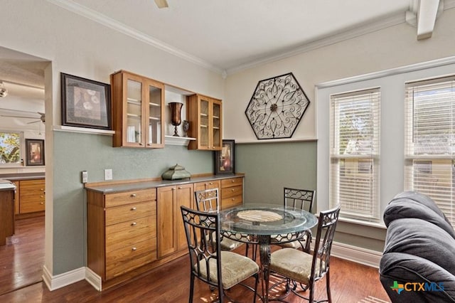 dining space with dark hardwood / wood-style floors and crown molding