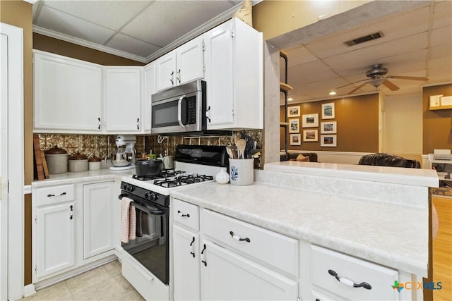 859 Pine St, New Braunfels, TX 78130 - kitchen with a paneled ceiling, stainless steel microwave, gas stove, open floor plan, and a ceiling fan