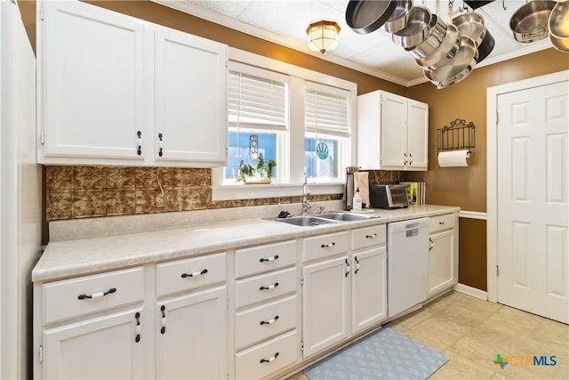 859 Pine St, New Braunfels, TX 78130 - kitchen featuring white dishwasher, a sink, white cabinetry, tasteful backsplash, and light countertops