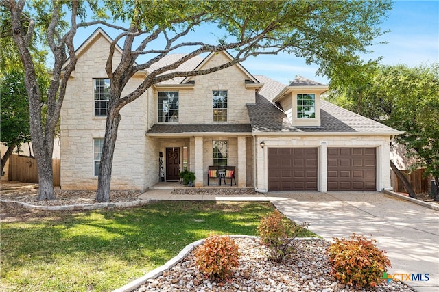 view of front of home featuring a garage and a front lawn