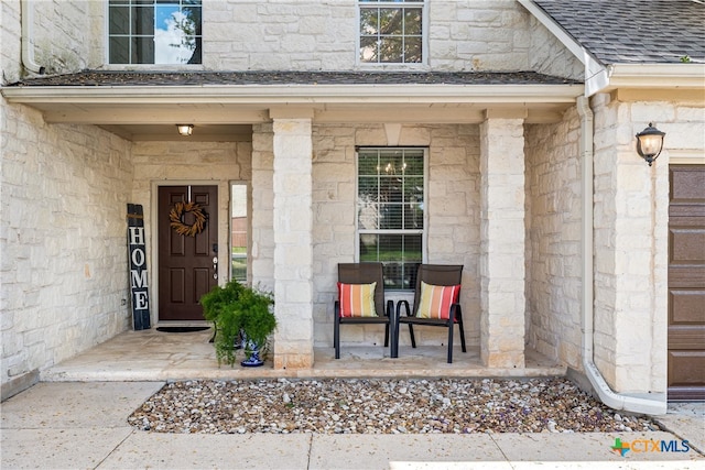 view of exterior entry with covered porch