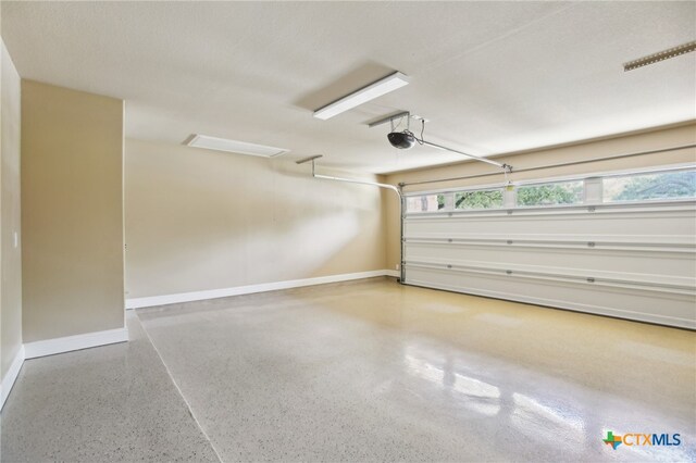 12109 Bryony Dr, Austin, TX 78739 - garage featuring baseboards and a garage door opener