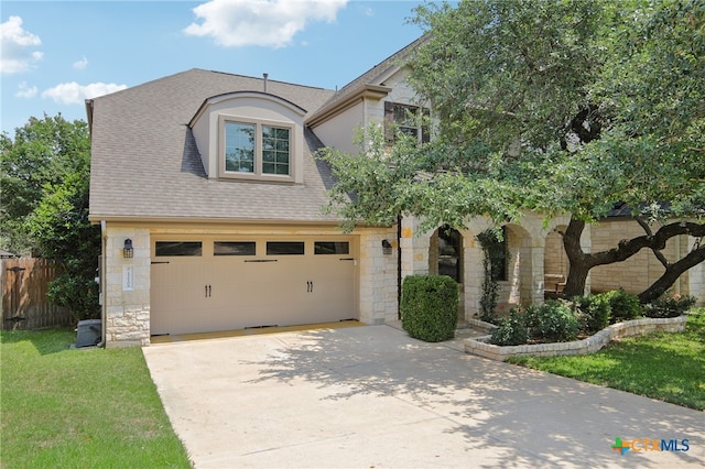 12109 Bryony Dr, Austin, TX 78739 - view of front of house featuring stone siding, driveway, roof with shingles, and a garage