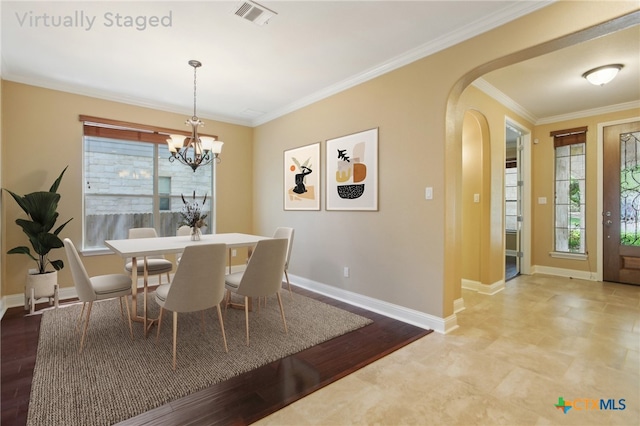 12109 Bryony Dr, Austin, TX 78739 - dining space featuring arched walkways, healthy amount of natural light, a chandelier, baseboards, and ornamental molding