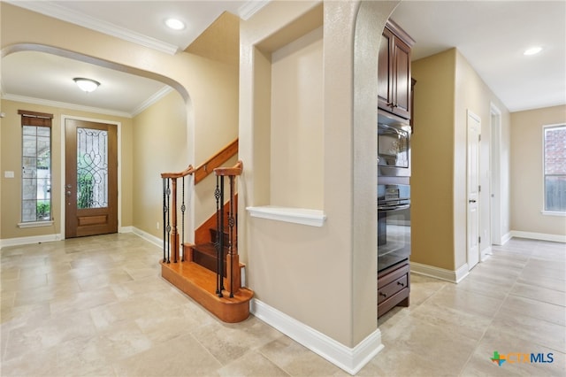 12109 Bryony Dr, Austin, TX 78739 - entrance foyer with ornamental molding, stairs, arched walkways, plenty of natural light, and baseboards