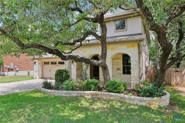 12109 Bryony Dr, Austin, TX 78739 - view of front of home featuring stone siding, concrete driveway, a garage, and stucco siding