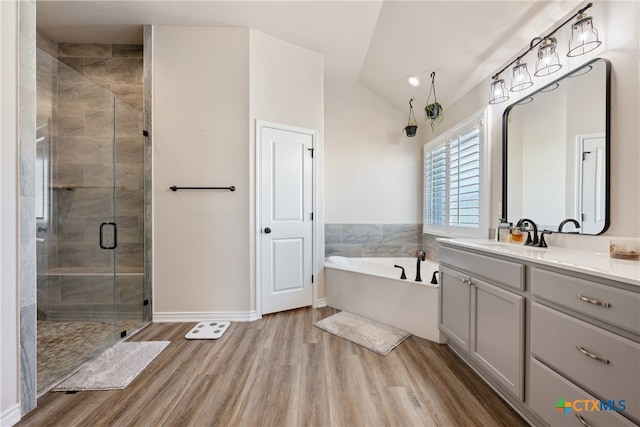 bathroom with vanity, plus walk in shower, vaulted ceiling, and wood-type flooring