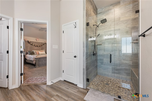 bathroom featuring an enclosed shower and hardwood / wood-style flooring