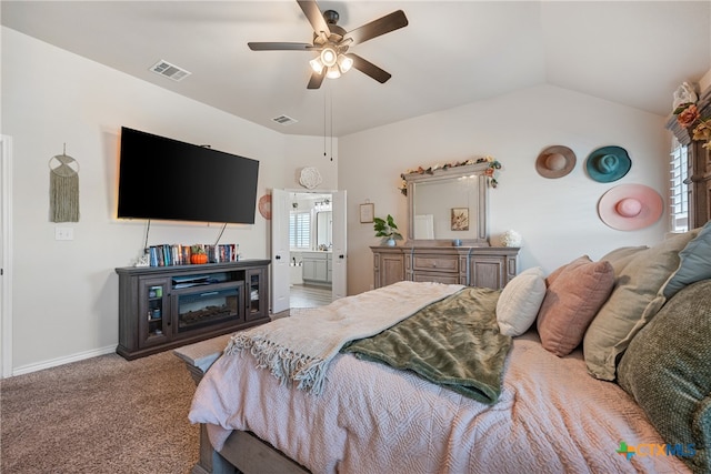 carpeted bedroom with ceiling fan, vaulted ceiling, and connected bathroom