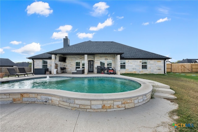 view of pool featuring a patio area, a lawn, and pool water feature