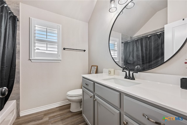 full bathroom with toilet, vanity, lofted ceiling, and hardwood / wood-style floors