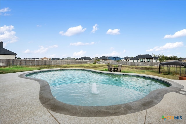 view of pool with a yard and a patio area