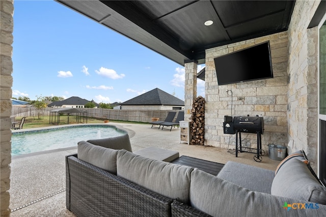 exterior space featuring an outdoor hangout area and a fenced in pool