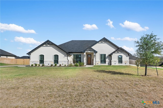 french provincial home with a front lawn