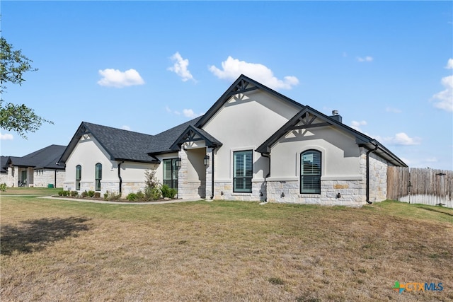 french provincial home with a front lawn