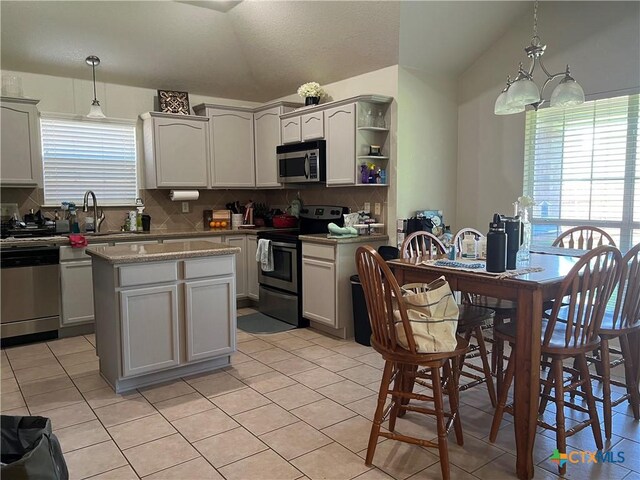 2019 Stonehenge Dr, Harker Heights, TX 76548 - kitchen with appliances with stainless steel finishes, backsplash, lofted ceiling, and light tile patterned floors