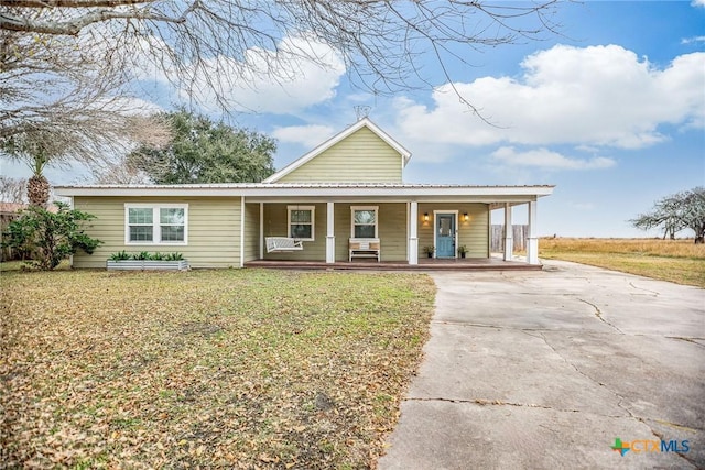 country-style home featuring covered porch and a front lawn