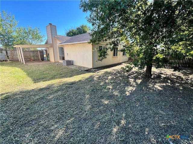 view of property exterior featuring a lawn and central AC unit