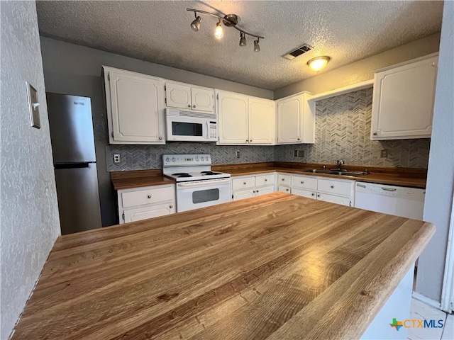 kitchen featuring wood counters, a textured ceiling, white appliances, sink, and white cabinetry