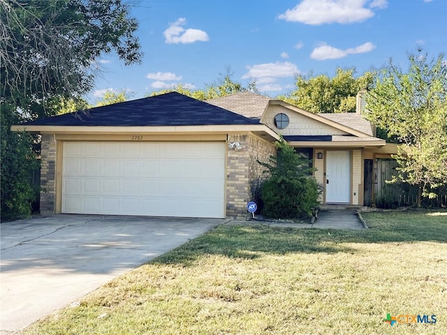 single story home featuring a front lawn and a garage