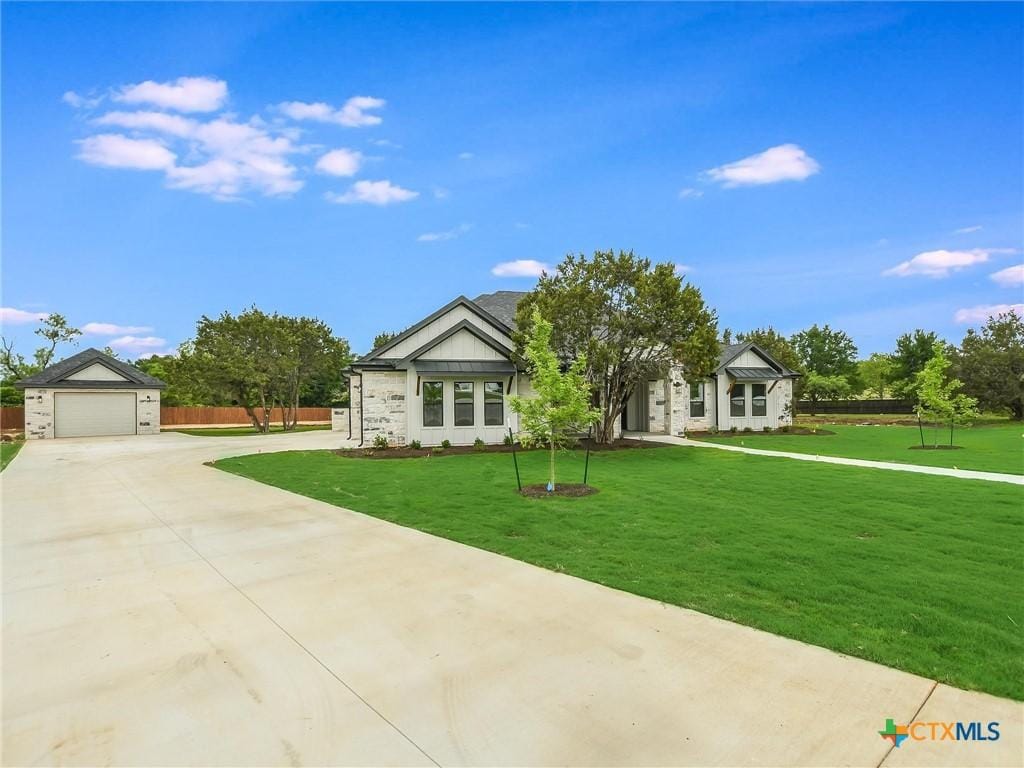 view of front of property featuring a garage and a front lawn