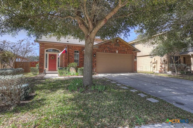 ranch-style house featuring brick siding, driveway, an attached garage, and fence