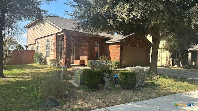 view of front of house with a garage and a front yard