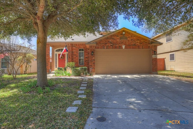 ranch-style home featuring concrete driveway, brick siding, and an attached garage