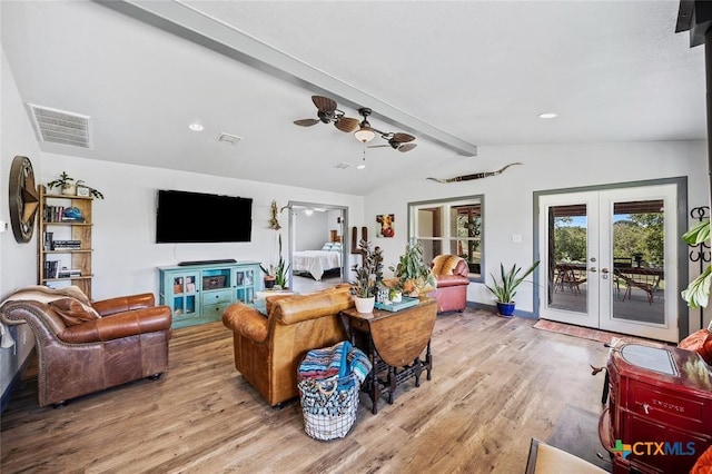 living room featuring vaulted ceiling with beams, visible vents, wood finished floors, and french doors