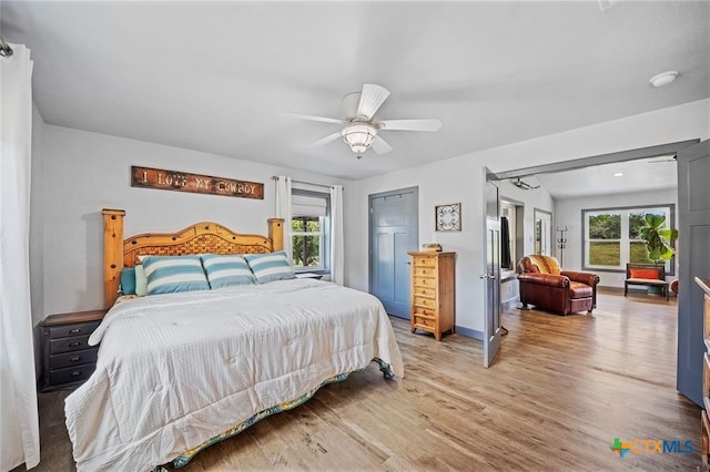 bedroom featuring baseboards, ceiling fan, and light wood-style floors