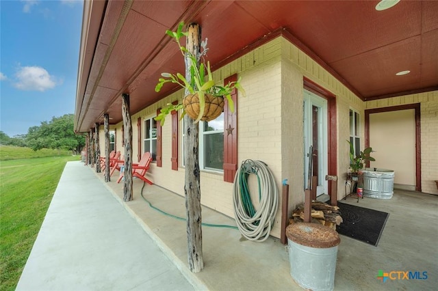 view of property exterior featuring brick siding and a yard