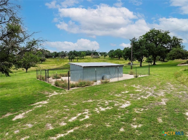 view of yard featuring an outdoor structure and fence