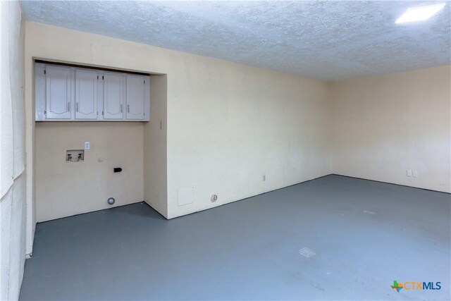 spare room featuring concrete floors and a textured ceiling