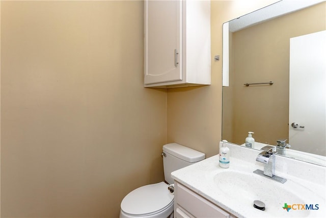 half bathroom featuring toilet and vanity