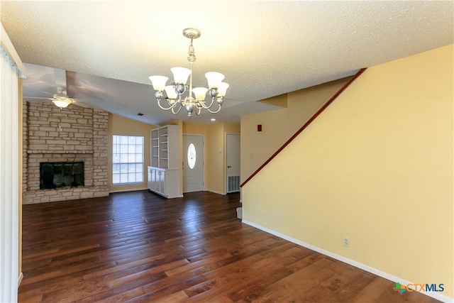 unfurnished living room with a textured ceiling, a fireplace, and dark wood-type flooring