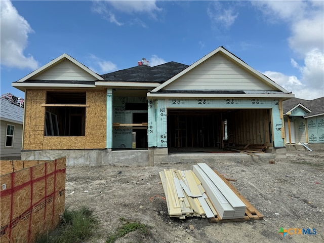 unfinished property featuring a garage