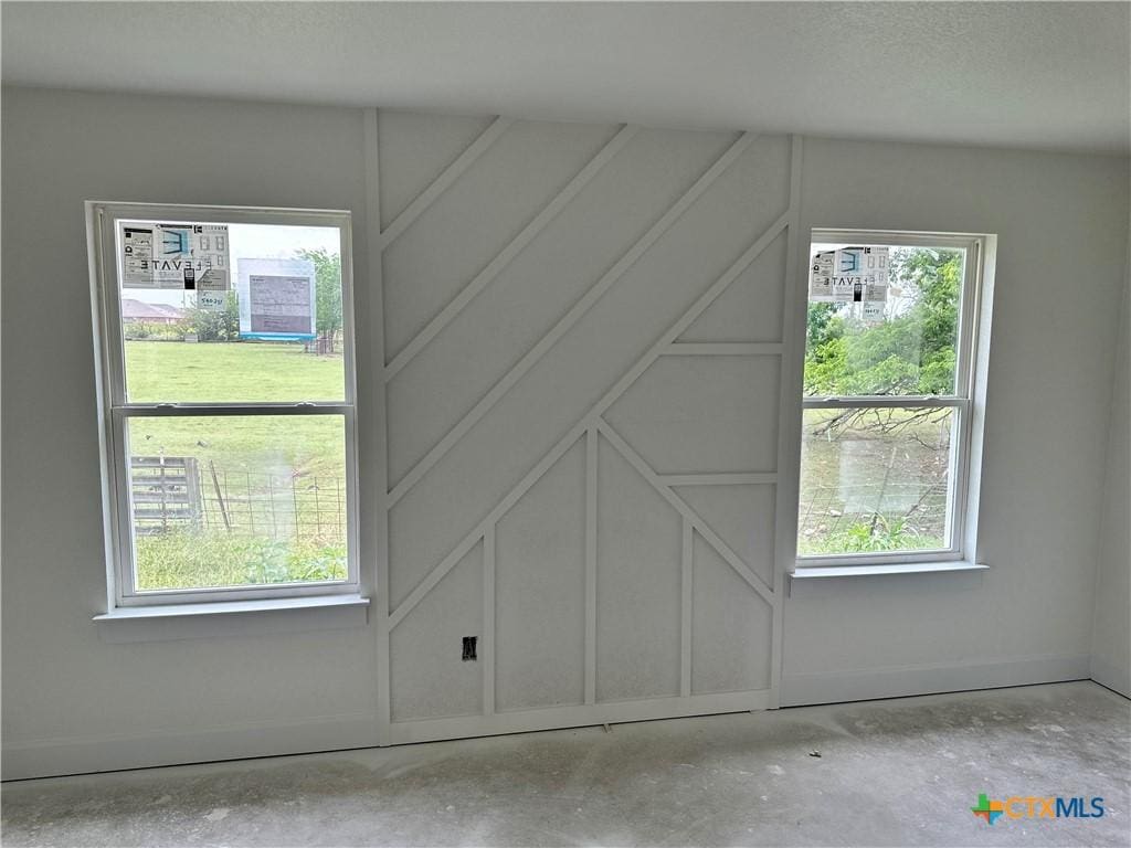 2115 Blackhawk Loop, Belton, TX 76513 - additional living space with concrete flooring, baseboards, and a decorative wall