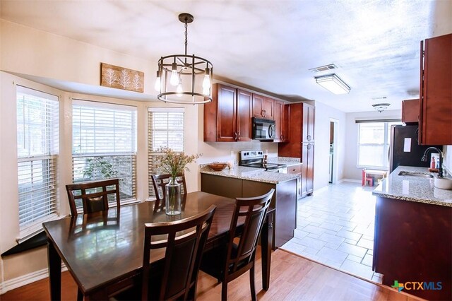 209 Brookway Dr, Killeen, TX 76542 - dining area featuring a chandelier and baseboards