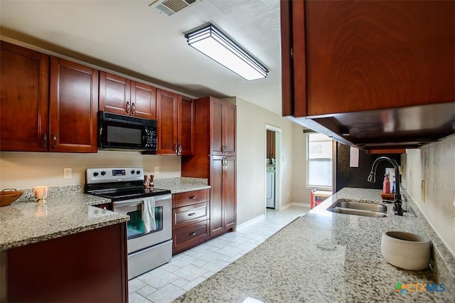 209 Brookway Dr, Killeen, TX 76542 - kitchen featuring black microwave, stainless steel electric stove, reddish brown cabinets, light stone countertops, and stone tile floors