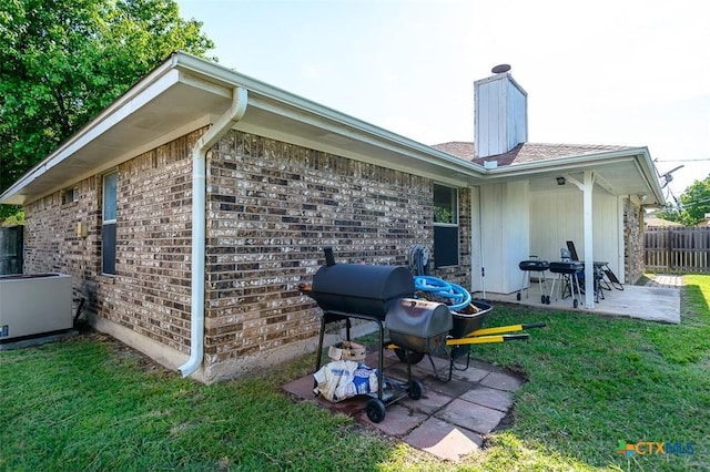 209 Brookway Dr, Killeen, TX 76542 - rear view of property featuring a patio area, a chimney, and brick siding