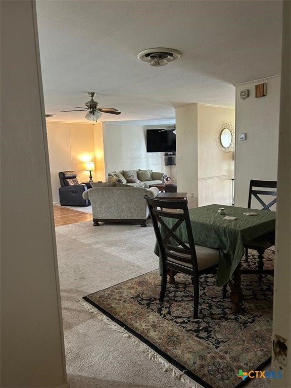 dining area with visible vents, carpet, and a ceiling fan