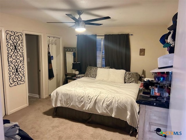 bedroom with carpet floors, ceiling fan, and baseboards