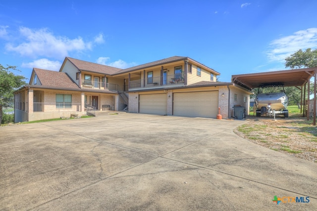 view of front of house with a garage and a carport